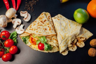 French pancakes dish with ingredients on dark background 