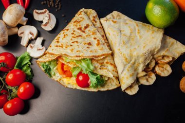 French pancakes dish with ingredients on dark background 