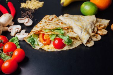 French pancakes dish with ingredients on dark background 