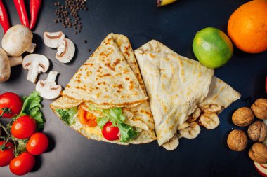 French pancakes dish with ingredients on dark background 