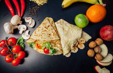 French pancakes dish with ingredients on dark background 