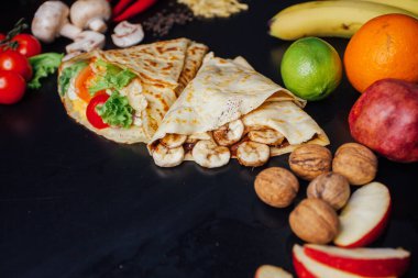 French pancakes dish with ingredients on dark background 