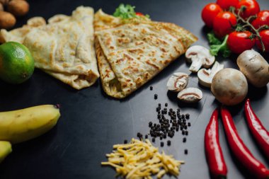 French pancakes dish with ingredients on dark background 