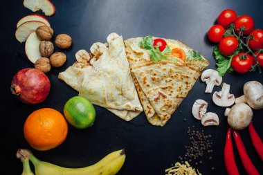 French pancakes dish with ingredients on dark background 