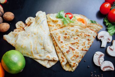 French pancakes dish with ingredients on dark background 