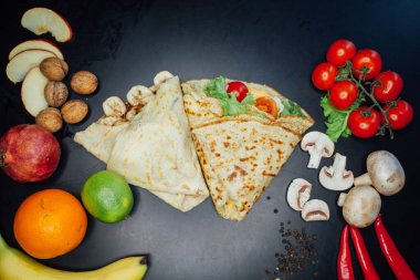 French pancakes dish with ingredients on dark background 