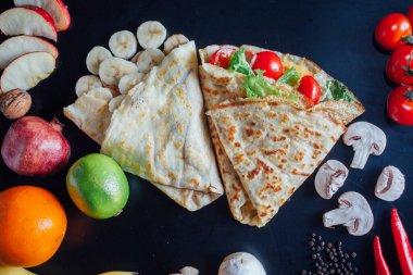French pancakes dish with ingredients on dark background 