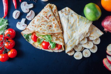 French pancakes dish with ingredients on dark background 
