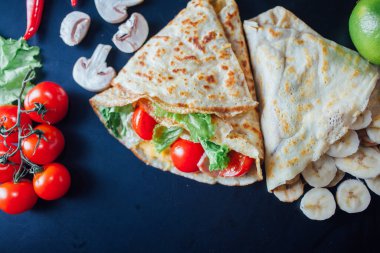 French pancakes dish with ingredients on dark background 
