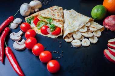 French pancakes dish with ingredients on dark background 