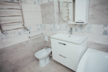 Modern bathroom wash basin with chrome faucet and gray tiling