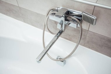 Faucet with shower in bathroom interior