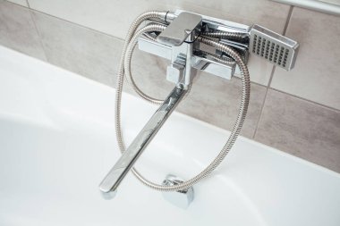 Faucet with shower in bathroom interior