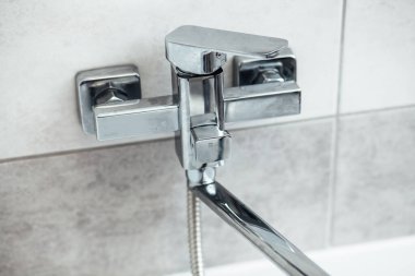 Modern bathroom wash basin with chrome faucet and gray tiling