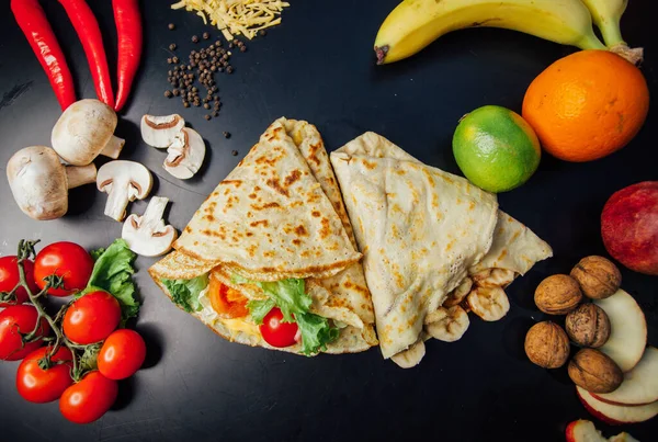 French pancakes dish with ingredients on dark background 