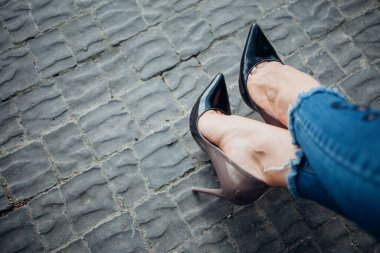 Siyah topuklu bir kadın. Yüksek topuklu kadın bacaklarının yakınlaşması