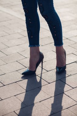 Siyah topuklu bir kadın. Yüksek topuklu kadın bacaklarının yakınlaşması