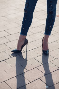 Siyah topuklu bir kadın. Yüksek topuklu kadın bacaklarının yakınlaşması