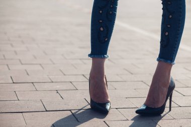 Siyah topuklu bir kadın. Yüksek topuklu kadın bacaklarının yakınlaşması