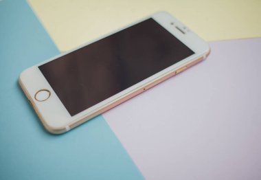 Renkli arkaplanda fotokopi alanı olan akıllı telefon. Modern ve minimal biçim rengi