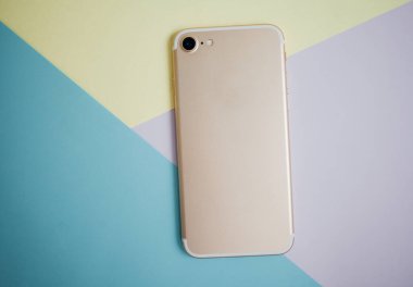 Renkli arkaplanda fotokopi alanı olan akıllı telefon. Modern ve minimal biçim rengi