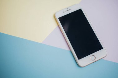 Renkli arkaplanda fotokopi alanı olan akıllı telefon. Modern ve minimal biçim rengi