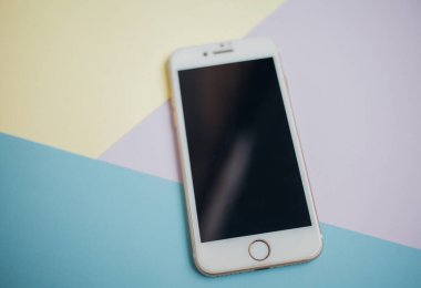 Renkli arkaplanda fotokopi alanı olan akıllı telefon. Modern ve minimal biçim rengi