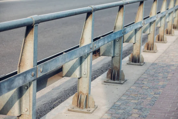 Road reflectors along the road. Metal road fencing of barrier type. Road and traffic safety.