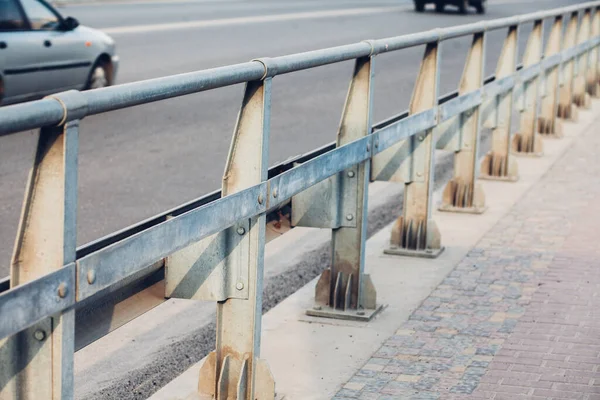 Road reflectors along the road. Metal road fencing of barrier type. Road and traffic safety.