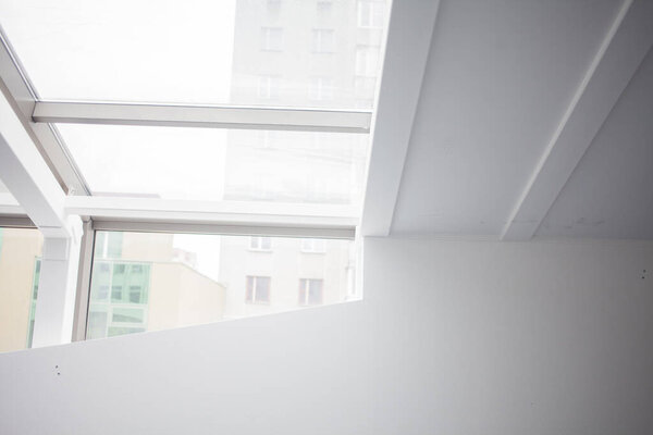 Empty white room with big windows