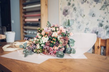 Bir buket çiçek masanın üzerinde duruyor.