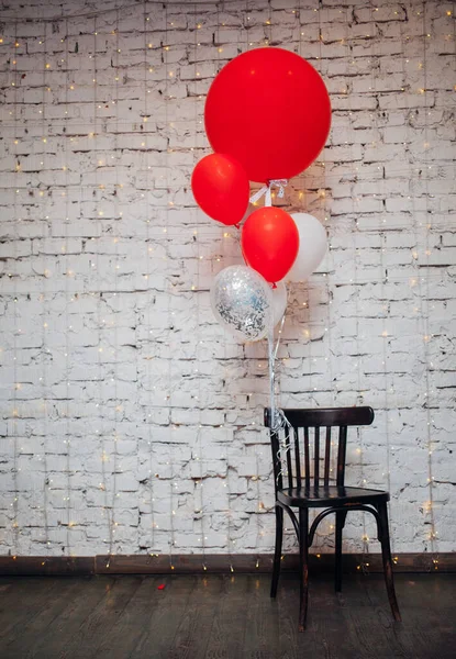 Tahta Koltuk Beyaz Tuğla Duvar Arka Planında Büyük Renkli Balonlar — Stok fotoğraf
