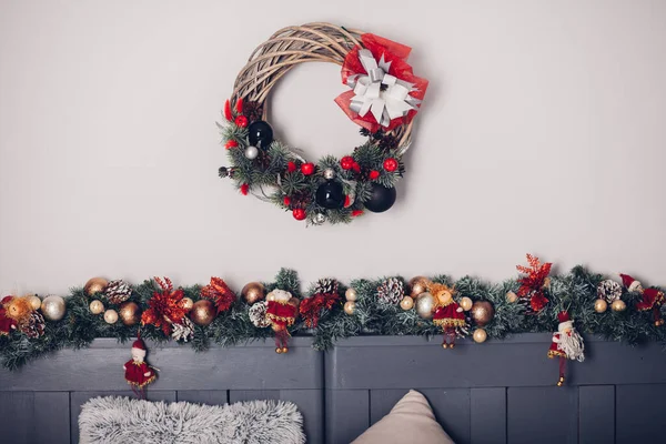 Bedroom decorated by Christmas. Cozy light interior, New Year\'s fir-tree decorated with toys and garlands