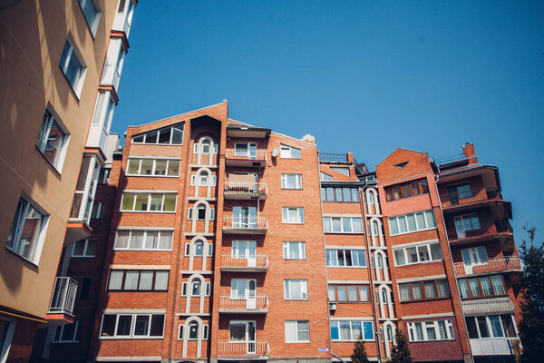 Modern apartment buildings on sunny day with a blue sky. Facade of a modern apartment building