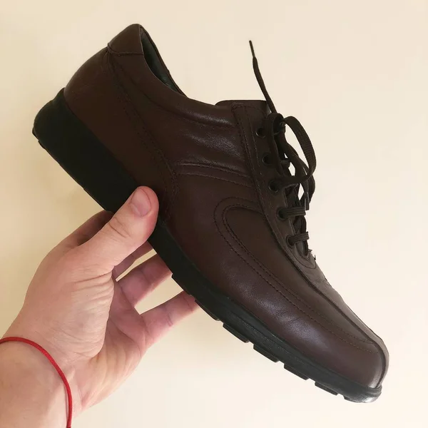 Primer Plano Mano Que Sostiene Zapato Masculino Sobre Fondo Blanco —  Fotos de Stock