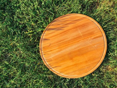 Yeşil çim arka planda yuvarlak ahşap tahta