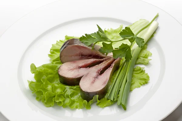 Smoked fish pieces with onion and parsley — Stock Photo, Image