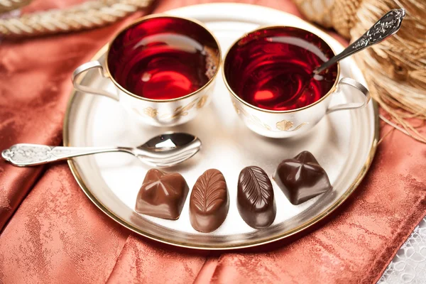 Chocolate candy, tea — Stock Photo, Image