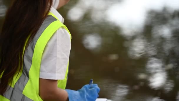 Female Ecologist Working Lake Taking Water Tests — Stock Video