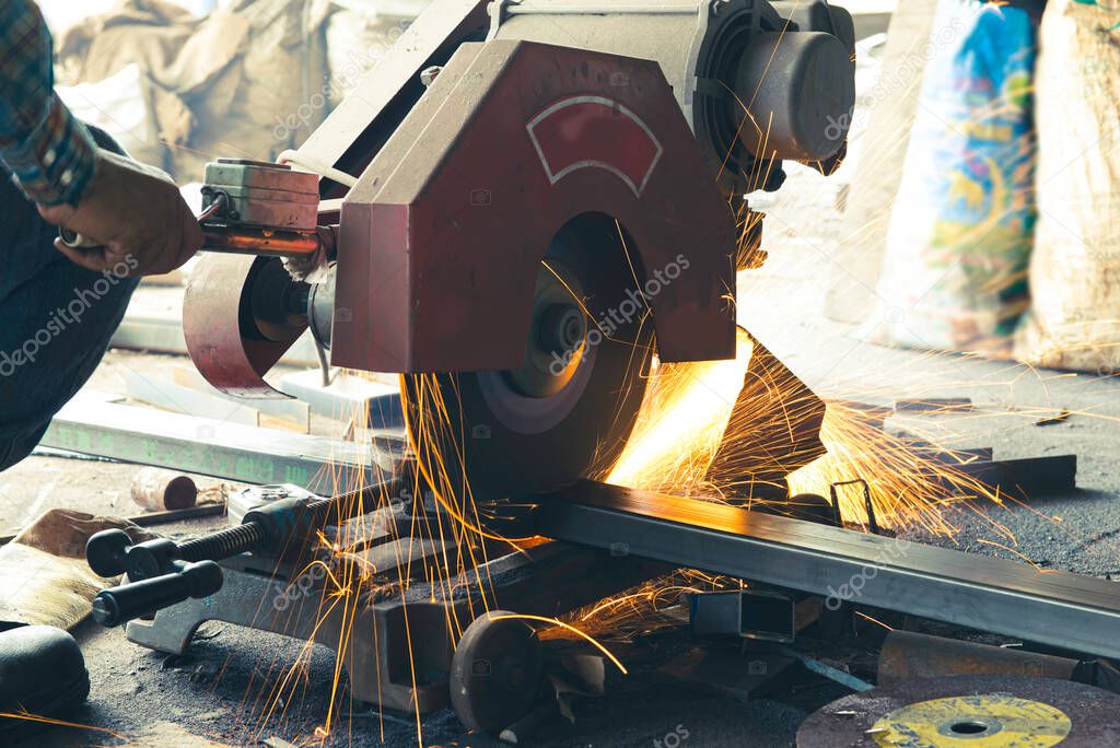 Welder cutting steel used to assemble truck parts