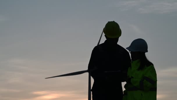 Silhouette Two Engineers Working Holding Report Wind Turbine Farm Power — Stock Video