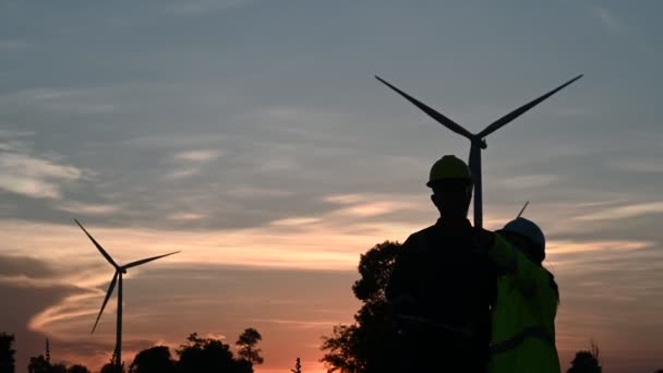 Silhouette Two Engineers Working Holding Report Wind Turbine Farm Power — Stock Video