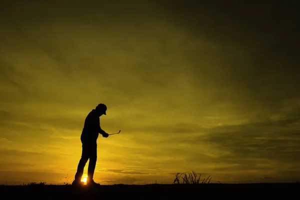 美丽的落日下 亚洲高尔夫球手打高尔夫的轮廓 — 图库照片