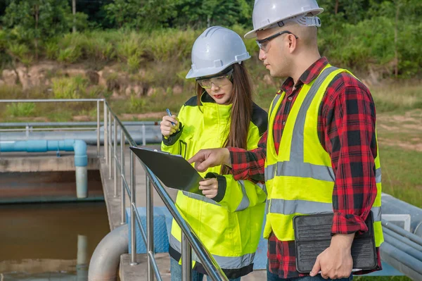 Environmental engineers work at wastewater treatment plants,Water supply engineering working at Water recycling plant for reuse,Technicians and engineers discuss work together.