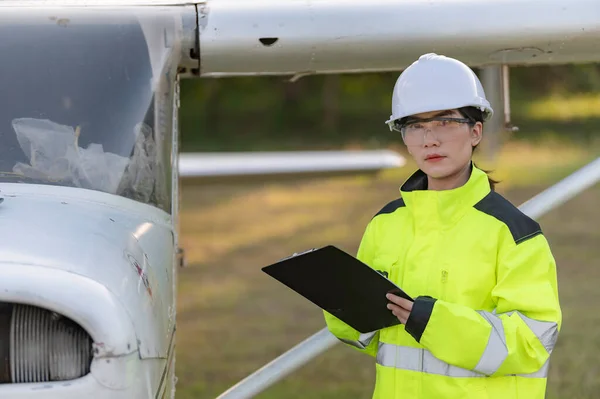 Technician fixing the engine of the airplane,Female aerospace engineering checking aircraft engines,Asian mechanic maintenance inspects plane engine