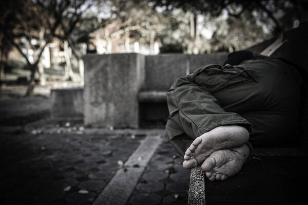 Asian man is homeless at the side road,A stranger has to live on the road alone because he has no family.