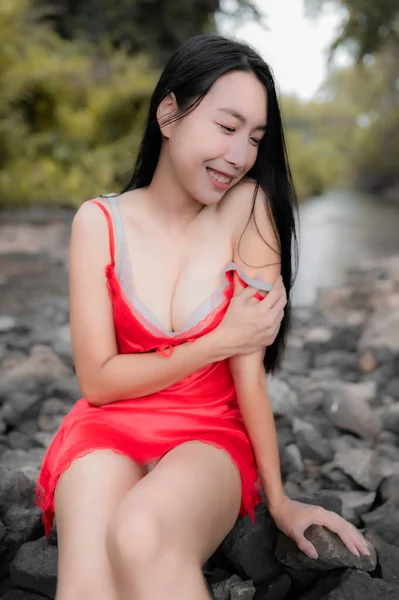 Portrait of sexy asian woman at the waterfall,Feeling fresh at the river,Thai female relax at country
