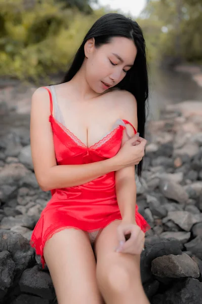 Portrait of sexy asian woman at the waterfall,Feeling fresh at the river,Thai female relax at country