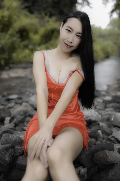 Portrait of sexy asian woman at the waterfall,Feeling fresh at the river,Thai female relax at country