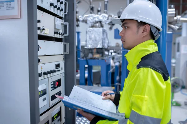 Electrical engineer woman checking voltage at the Power Distribution Cabinet in the control room,preventive maintenance Yearly,Thailand Electrician working at company